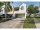 View of the condo featuring an attached garage, outdoor seating, and well-maintained landscaping at 2387 Hanover Dr # 2387, Dunedin, FL 34698
