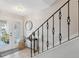 Bright foyer with tile flooring, staircase, and a decorative table, offering a stylish welcome to the home at 2387 Hanover Dr # 2387, Dunedin, FL 34698