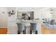 Modern kitchen with stainless steel appliances, a breakfast bar and stylish bar stools at 2387 Hanover Dr # 2387, Dunedin, FL 34698
