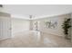 Bright, open living room features tile flooring, neutral walls, and sliding glass doors to balcony at 2387 Hanover Dr # 2387, Dunedin, FL 34698