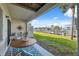 Patio featuring stylish outdoor seating, a table, and a view of the waterfront with a well-maintained lawn at 2387 Hanover Dr # 2387, Dunedin, FL 34698