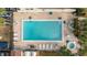 Aerial shot of a community pool with sun loungers and a spa, set within a paved patio area at 2387 Hanover Dr # 2387, Dunedin, FL 34698