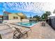 Resort-style pool with lounge chairs, surrounded by palm trees and a patio, set in a relaxing atmosphere at 2387 Hanover Dr # 2387, Dunedin, FL 34698