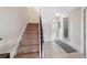 Staircase with carpeted steps and metal railing, leading to the upper level of the home, next to a bathroom at 2387 Hanover Dr # 2387, Dunedin, FL 34698