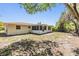 Backyard features a screened-in patio and a partially fenced-in yard with lots of shade trees at 2551 Fentress Pl, Holiday, FL 34691