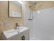 This bathroom has light tan walls, a modern vanity and a tiled shower at 2551 Fentress Pl, Holiday, FL 34691