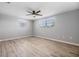 This bedroom has wood look flooring, a ceiling fan, and natural light from the windows at 2551 Fentress Pl, Holiday, FL 34691