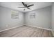 Bedroom with gray walls, two windows and wood look flooring at 2551 Fentress Pl, Holiday, FL 34691