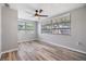 This bedroom has light gray walls, two windows and wood look flooring at 2551 Fentress Pl, Holiday, FL 34691