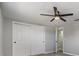 Bedroom features light gray walls, an updated ceiling fan and a large closet with sliding doors at 2551 Fentress Pl, Holiday, FL 34691