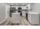 Modern kitchen with stainless steel appliances, island, and sleek white cabinets at 2551 Fentress Pl, Holiday, FL 34691