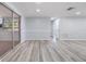 Spacious living area with slider door access to an enclosed sunroom and backyard at 2551 Fentress Pl, Holiday, FL 34691