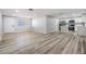 Open concept living area featuring modern floors and leads into a newly updated kitchen at 2551 Fentress Pl, Holiday, FL 34691