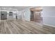 Open floor plan with new flooring connects the living room and kitchen seamlessly at 2551 Fentress Pl, Holiday, FL 34691