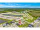 Scenic aerial view of a residential area with ponds and neatly arranged homes and roadways at 2760 Winding Creek Trl, North Port, FL 34289