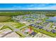 Aerial view of a lakeside community featuring modern homes, green spaces, and scenic waterways at 2760 Winding Creek Trl, North Port, FL 34289