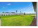Large backyard with green grass, perimeter fence and landscaping at 2760 Winding Creek Trl, North Port, FL 34289