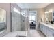 Bright bathroom with a glass walk-in shower, double vanity, and neutral tones at 2760 Winding Creek Trl, North Port, FL 34289