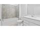 Bathroom with modern finishes, featuring a tiled shower/tub and white vanity at 2760 Winding Creek Trl, North Port, FL 34289