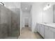 Bright bathroom featuring a tiled shower and vanity with white cabinets at 2760 Winding Creek Trl, North Port, FL 34289