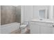 Well lit, modern bathroom with tiled shower and vanity with white cabinets at 2760 Winding Creek Trl, North Port, FL 34289