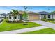 Inviting single-Gathering home featuring lush green lawn and mature trees enhancing the curb appeal at 2760 Winding Creek Trl, North Port, FL 34289