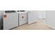 Modern laundry room with white washer and dryer at 2760 Winding Creek Trl, North Port, FL 34289