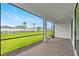 Covered patio with brick flooring, black railings, and a view of the backyard at 2760 Winding Creek Trl, North Port, FL 34289