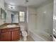Bright, tiled bathroom with bathtub and single sink vanity at 2837 Santego Bay Ct, Brandon, FL 33511