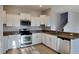 Modern kitchen with white cabinetry, granite countertops, and stainless steel appliances at 2837 Santego Bay Ct, Brandon, FL 33511