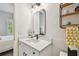 Bathroom featuring a modern vanity with a mirror and stylish decor at 3607 W Roland St, Tampa, FL 33609