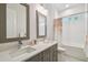 Bathroom featuring double vanity, modern fixtures, and a combined tub and shower at 3607 W Roland St, Tampa, FL 33609