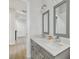 Bathroom featuring a double vanity, modern fixtures, and a bright neutral color palette at 3607 W Roland St, Tampa, FL 33609