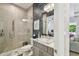 Elegant bathroom showcasing an attractive stone sink, seamless glass shower, and a modern lighting fixture at 3607 W Roland St, Tampa, FL 33609