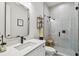 Modern bathroom with a glass-enclosed shower, decorative tiles, and stylish fixtures at 3607 W Roland St, Tampa, FL 33609