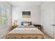 Cozy bedroom with a comfortable bed, natural light, and minimalist decor at 3607 W Roland St, Tampa, FL 33609