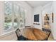 Bright dining nook featuring an oval wood table, shuttered windows overlooking pool and backyard views at 3607 W Roland St, Tampa, FL 33609