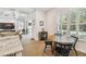 Cozy dining area features a round table, large windows, and seamless transition to the outdoor pool area at 3607 W Roland St, Tampa, FL 33609