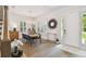 Bright dining room with natural light, plantation shutters, a modern chandelier, and wood floors at 3607 W Roland St, Tampa, FL 33609