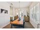 Dining area featuring a modern chandelier, wood floors, and an adjacent bar area with a wine cooler at 3607 W Roland St, Tampa, FL 33609