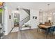 Inviting entryway featuring wood floors, staircase, and a dining area with a stylish chandelier at 3607 W Roland St, Tampa, FL 33609