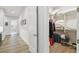 Hallway leading to closet with white wire shelving, luggage, and folded linens at 3607 W Roland St, Tampa, FL 33609