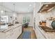 Bright, modern kitchen with marble counters, stainless appliances, and a view of the outdoor dining area at 3607 W Roland St, Tampa, FL 33609