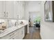 Modern kitchen with white cabinetry, marble countertops, and a wine fridge on hardwood floors at 3607 W Roland St, Tampa, FL 33609
