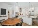 Modern kitchen with white cabinets, stainless appliances, marble countertops, and an adjacent dining area at 3607 W Roland St, Tampa, FL 33609