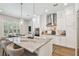 Updated kitchen features marble countertops, stainless steel appliances, and a center island with barstools at 3607 W Roland St, Tampa, FL 33609