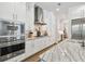 Modern kitchen with stainless steel appliances, white cabinets and marble countertops at 3607 W Roland St, Tampa, FL 33609