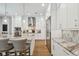 Bright kitchen featuring a marble backsplash, stainless steel appliances, and modern white cabinetry at 3607 W Roland St, Tampa, FL 33609