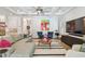 Bright living room with coffered ceilings and neutral-toned furniture on a hardwood floor with white and black rug at 3607 W Roland St, Tampa, FL 33609