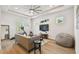 Relaxing living room with comfortable seating, a large ceiling fan, and hardwood floors at 3607 W Roland St, Tampa, FL 33609